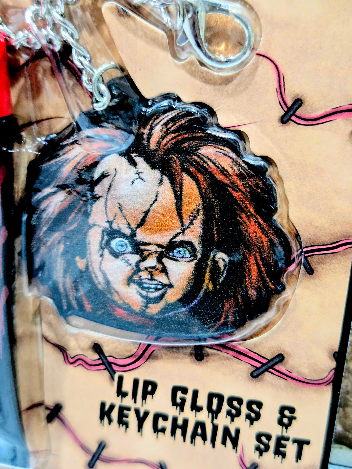 Chucky character keychain with “Lip Gloss & Keychain Set” text