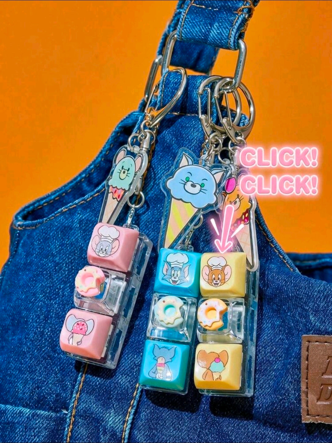 Multiple Tom & Jerry dessert keyboard fidget clicker keychains on blue jeans with character charms