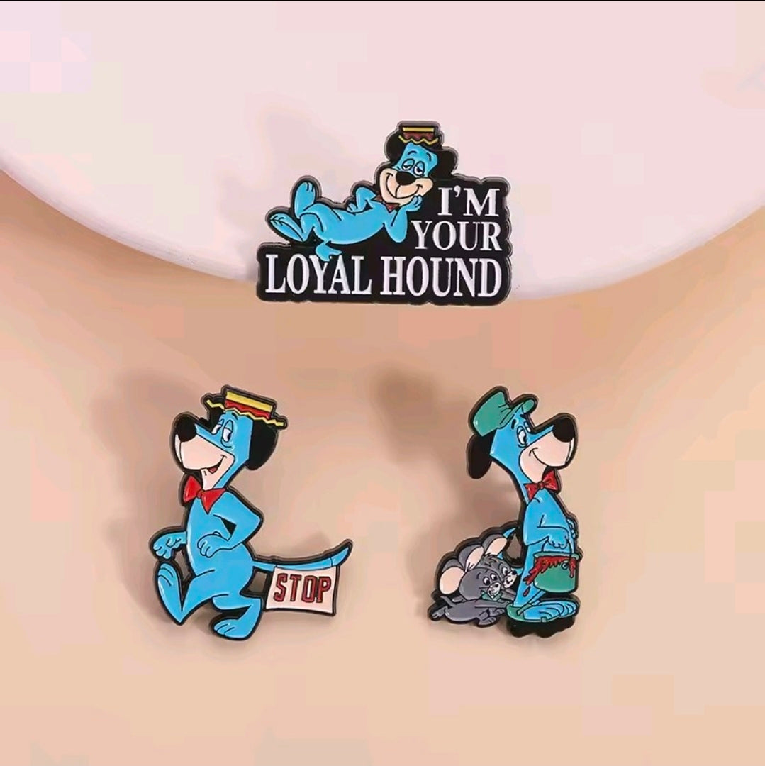 Three enamel pins: Loyal Hound center, STOP, and gray-hound character pins