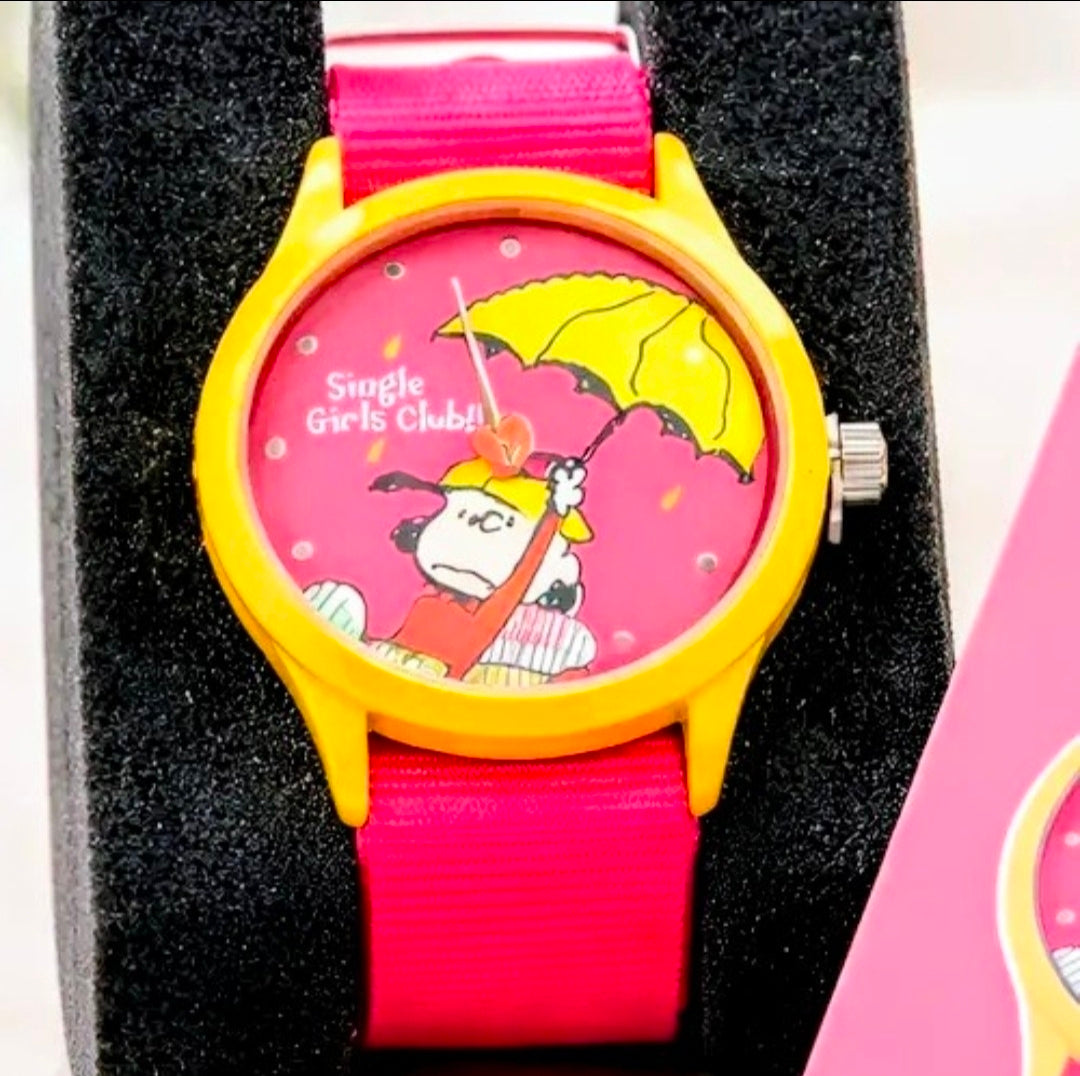 Girls wristwatch with pink strap and yellow case, pink dial featuring Snoopy graphic
