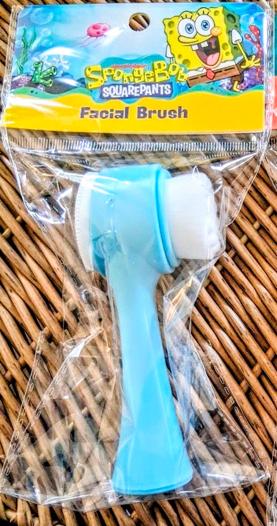 Blue facial brush in clear package on wicker basket