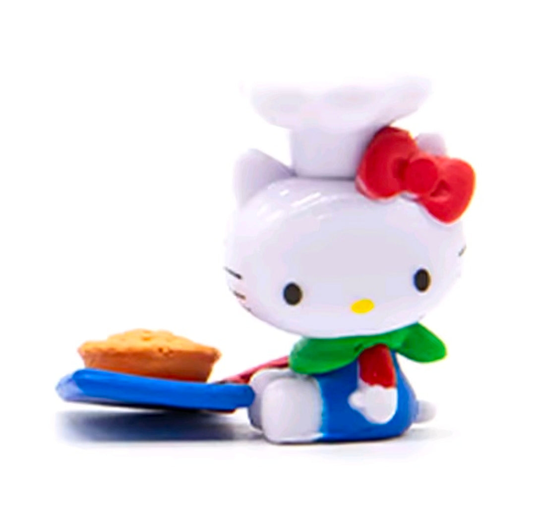 Hello Kitty mini figure with red bow, green apron, and tray with orange snack