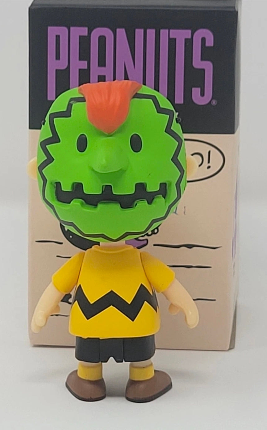 Halloween vinyl blind box figure in a green monster face costume with orange hair