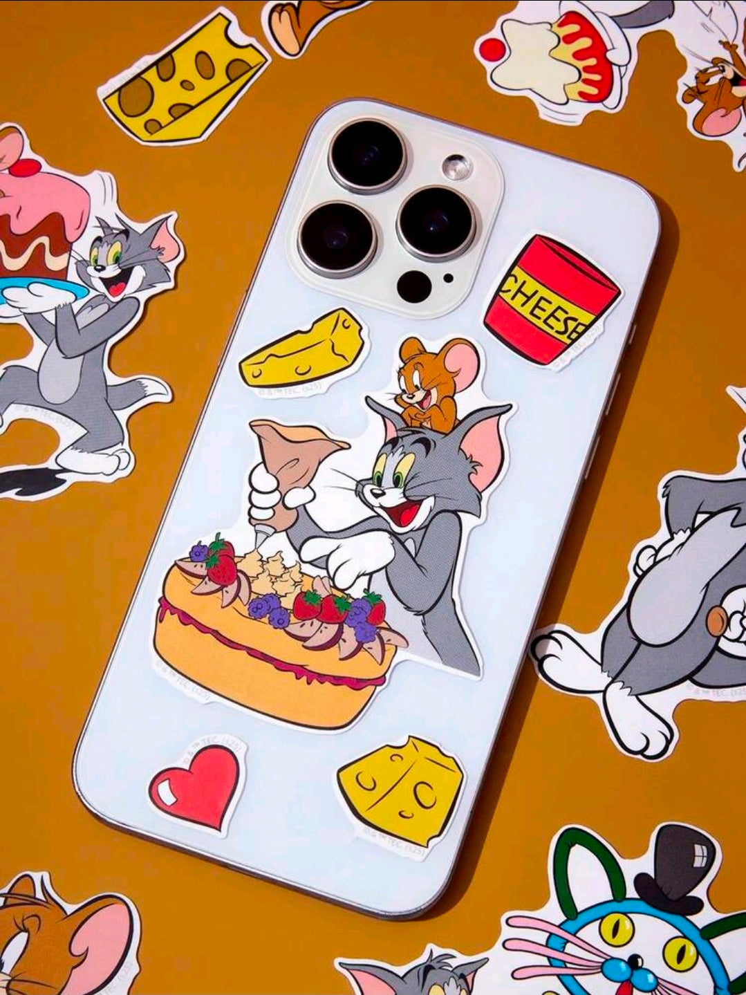 Tom and Jerry vinyl character stickers on a white phone case with hearts and cheese