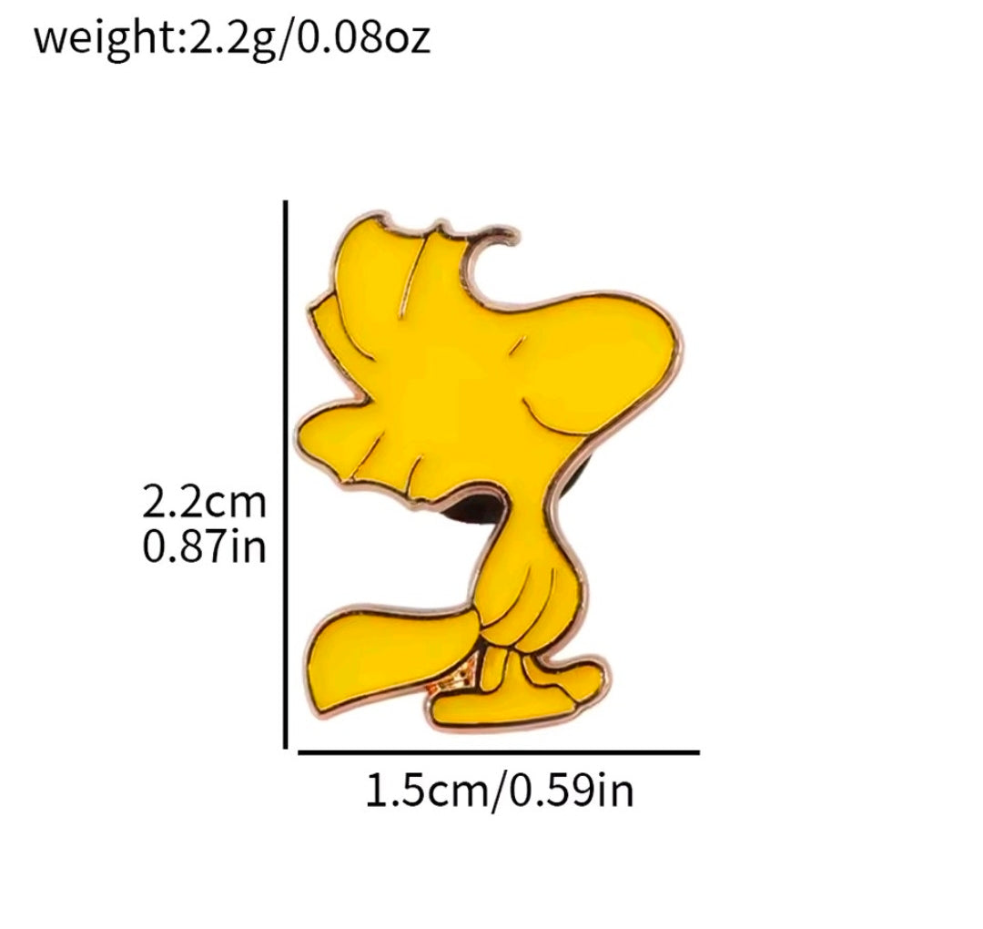 Yellow bird-shaped enamel pin with brown outline and raised details