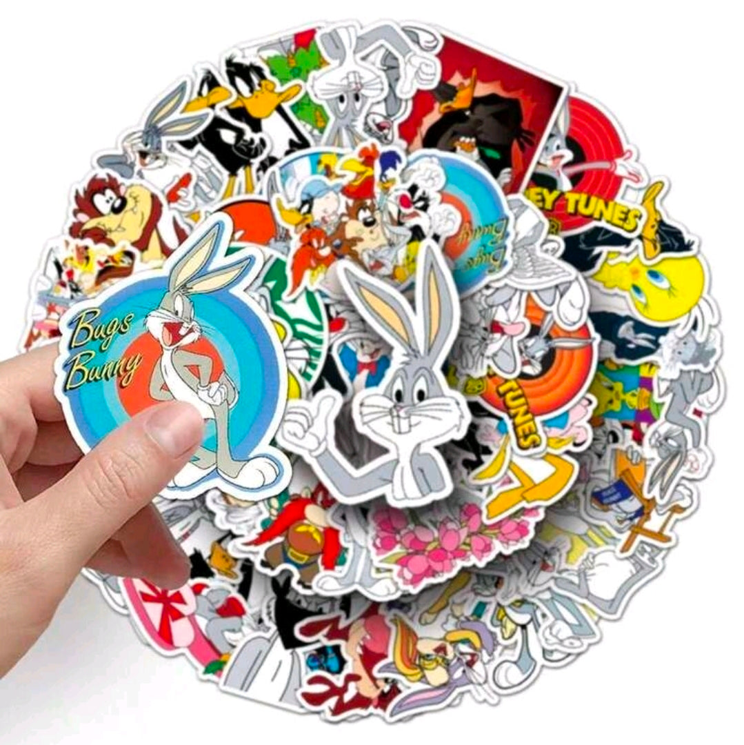 Hand holding a round bundle of Looney Tunes vinyl decal stickers with mixed characters