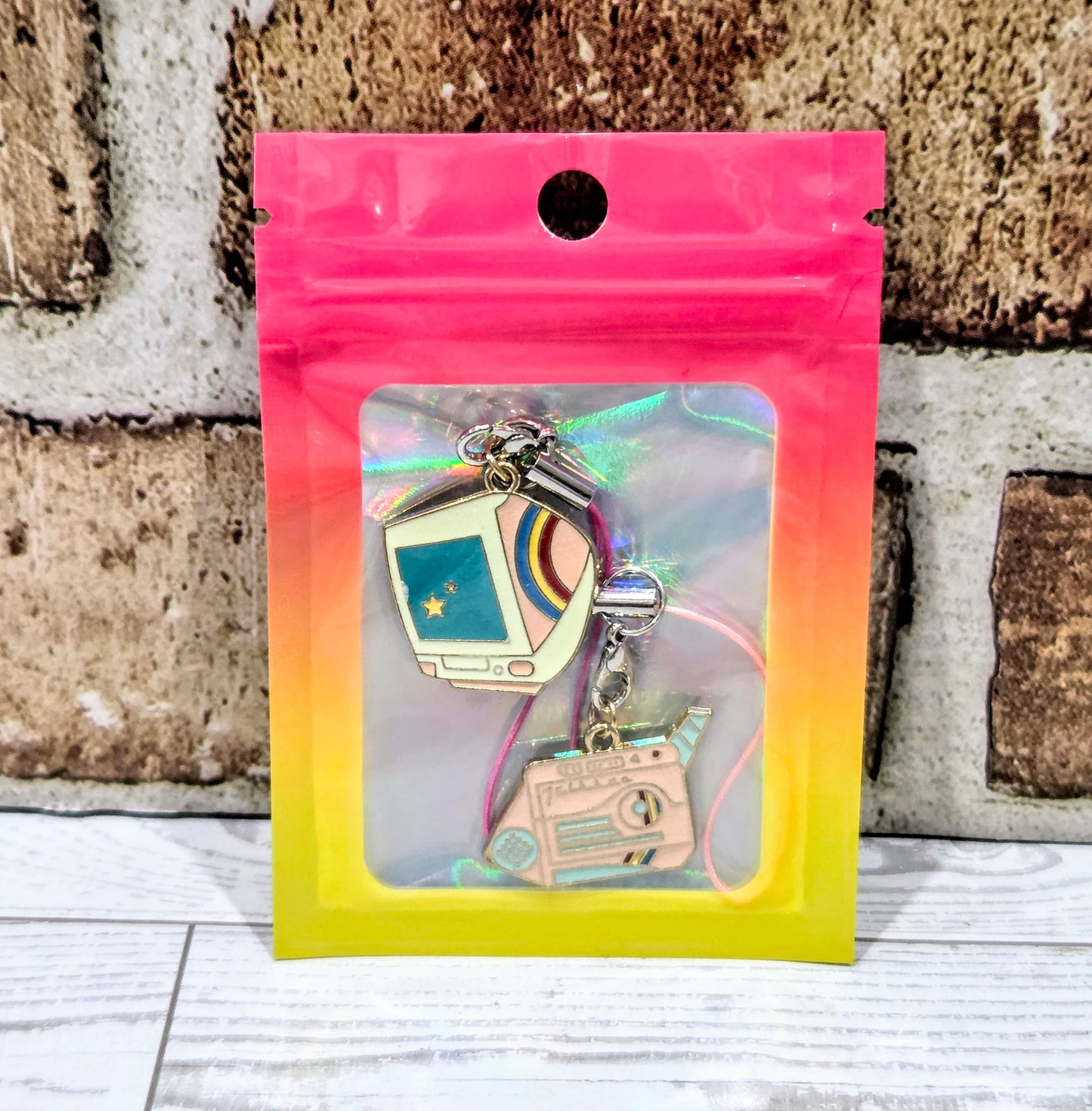Packaged retro phone charm set with teal computer screen and pink lanyard cords