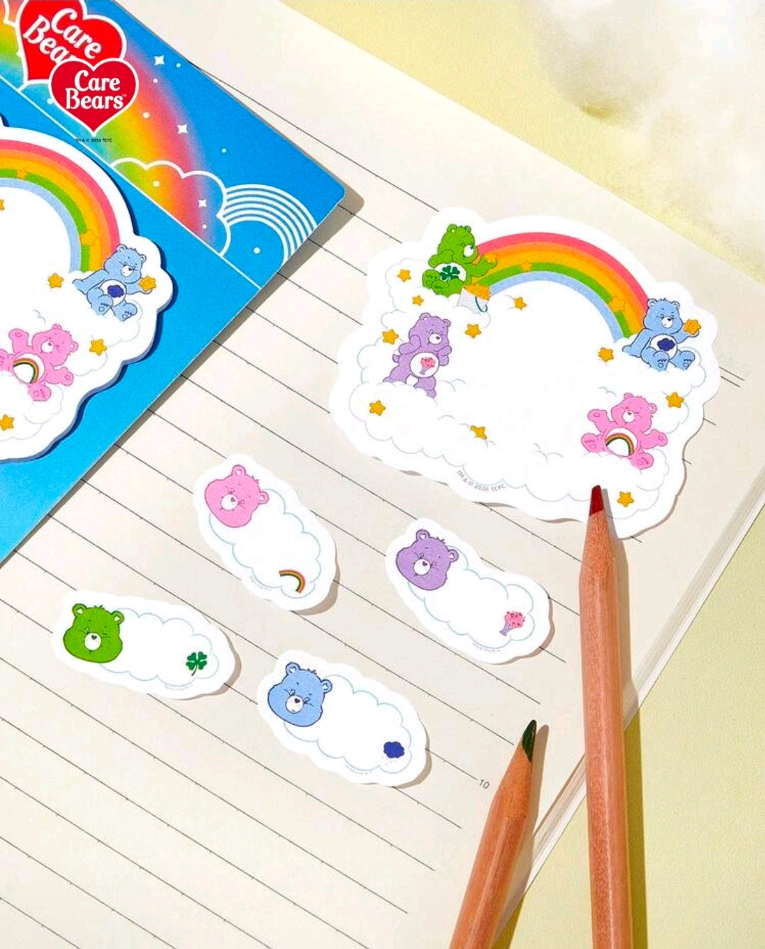 Care Bears sticky tabs with rainbow cloud cutouts and small character clouds, on lined paper