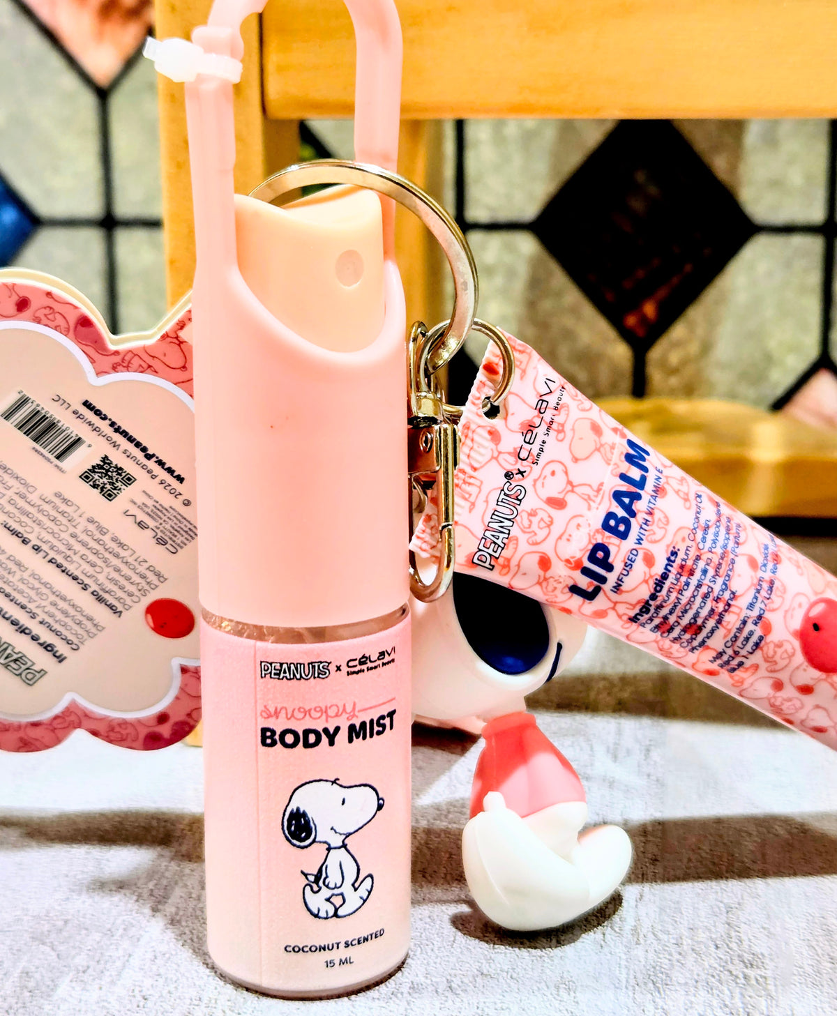 Body mist bottle keychain with Snoopy label and pink carry ring