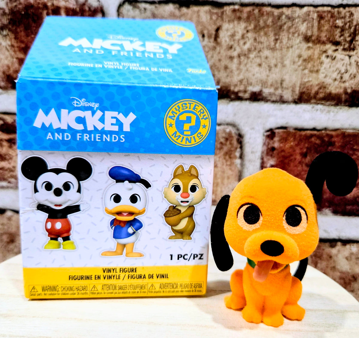 Disney Mickey and Friends mystery mini box with Pluto plush figure on display