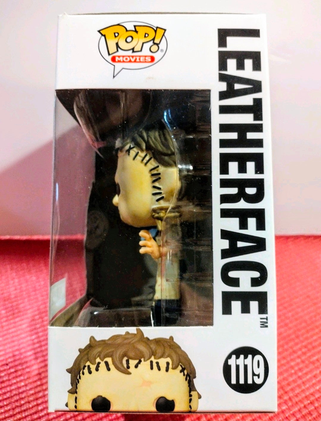 Vinyl figure box with side view window showing Leatherface character