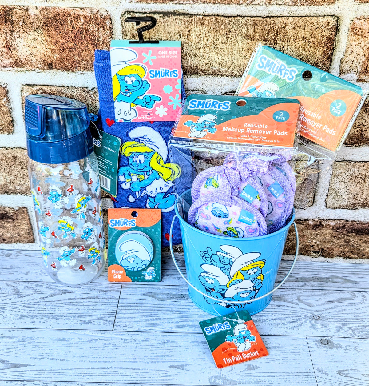 Smurfs self-care gift set with blue water bottle, socks, and makeup remover pads