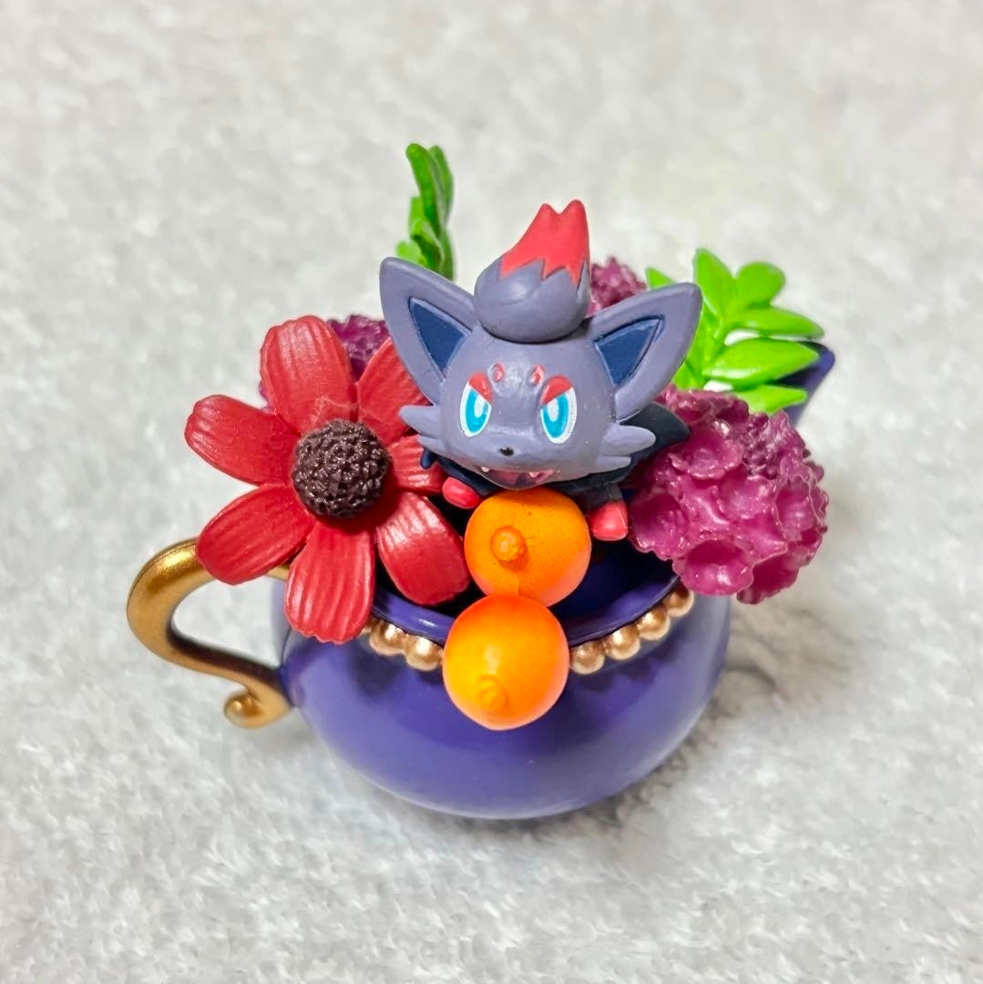 Lavender teacup mini figure with grey cat and red, purple, orange floral arrangement