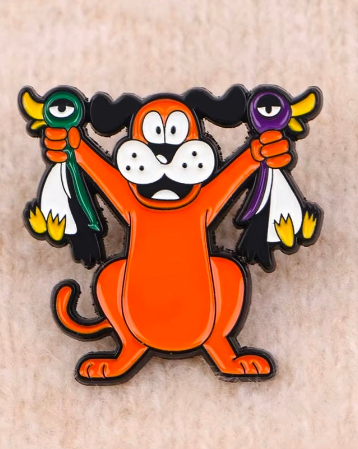 Orange cartoon dog enamel lapel pin with white face and purple and green accents.
