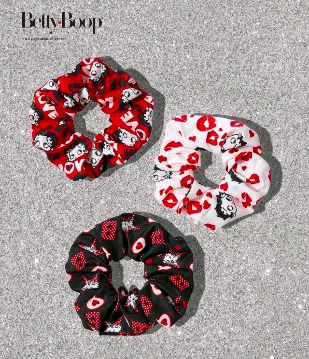 Three character print scrunchies in red, white, and black with hearts and bows