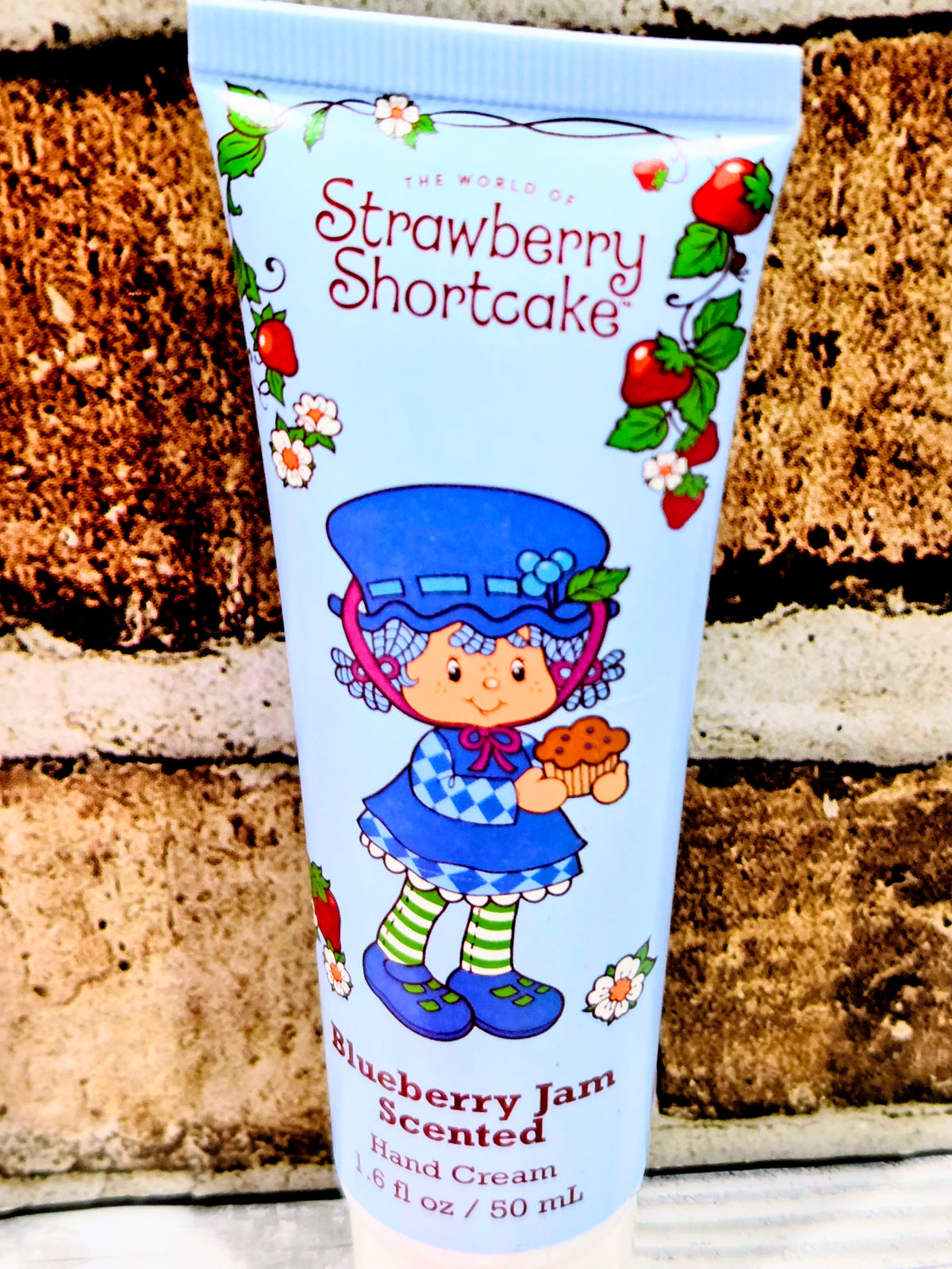 Strawberry Shortcake hand cream tube labeled Blueberry Jam scented, with cartoon girl