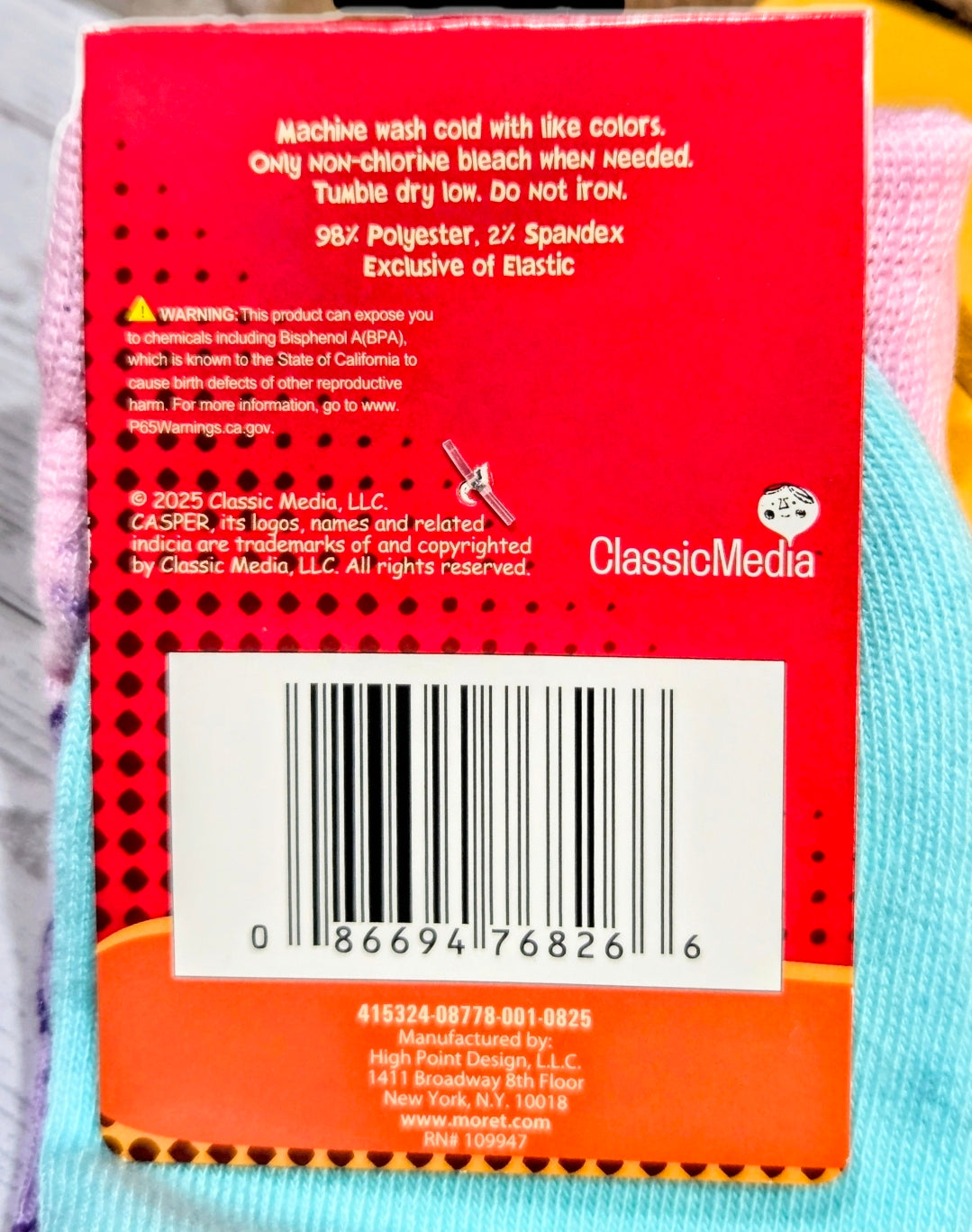 Crew socks with light blue knit and purple trim, with care label