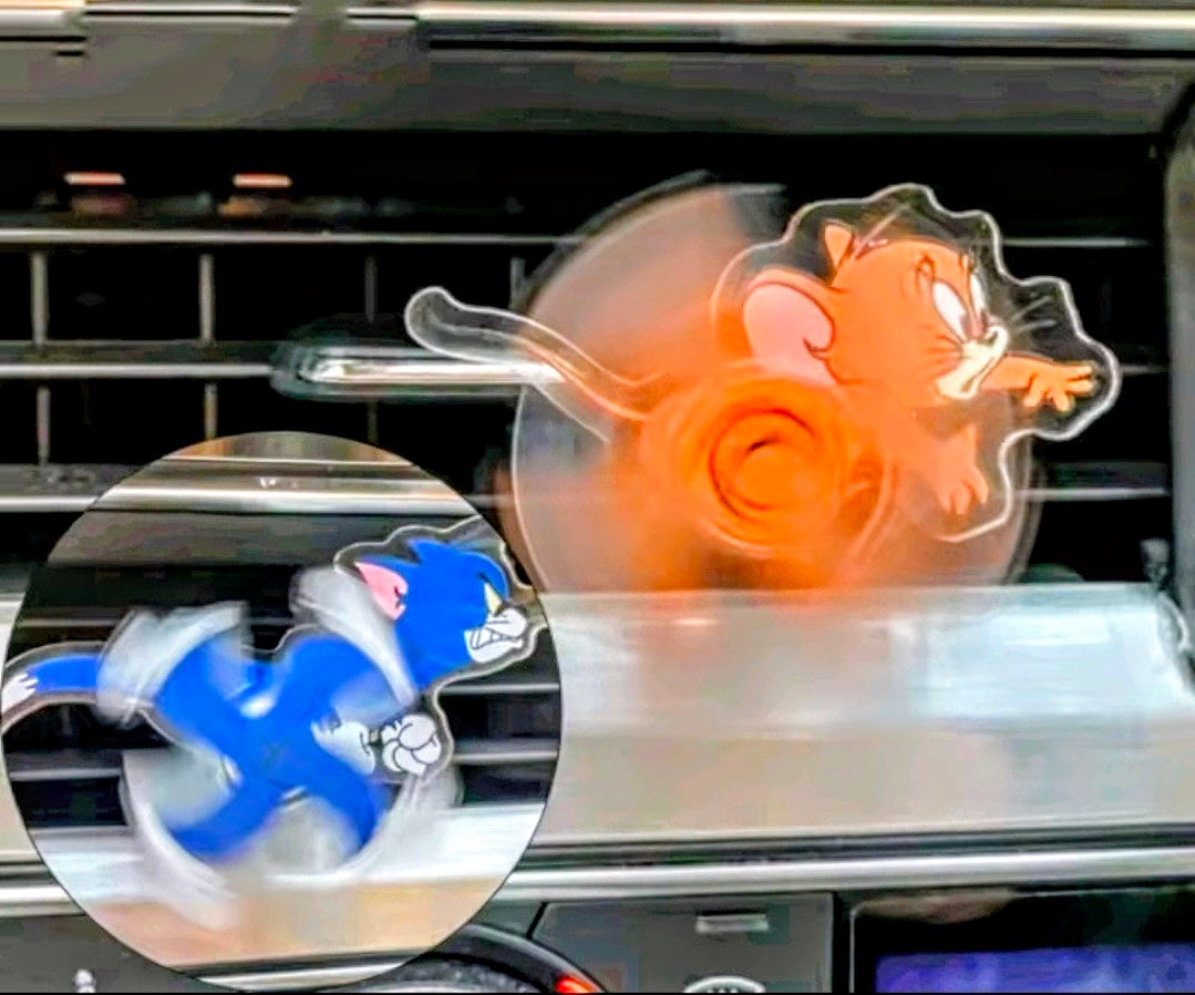 Orange and blue cartoon cat acrylic air-vent spinner clips in car vent.