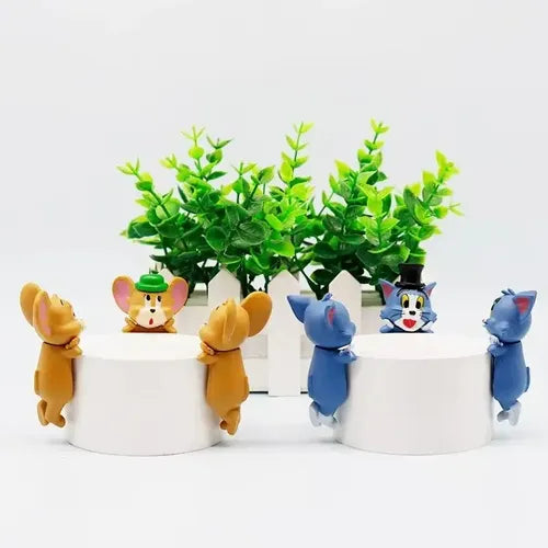 HIPPERS collectible figures perched by white planters with green leaf trees