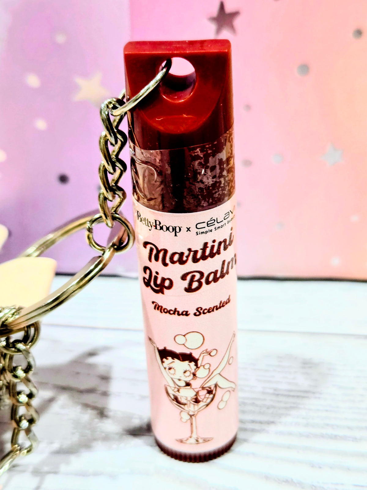 Martini lip balm tube labeled Mocha Scuffle with red cap and Betty Boop graphic