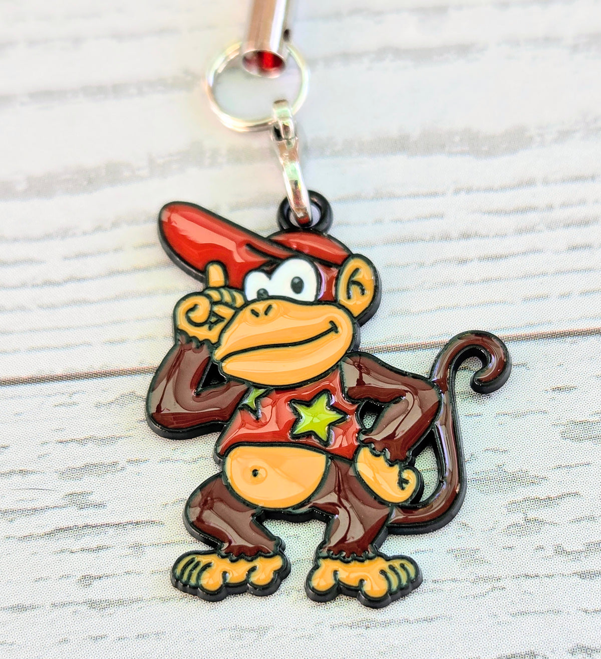 Donkey Kong enamel phone charm with red cap, star shirt, and silver ring