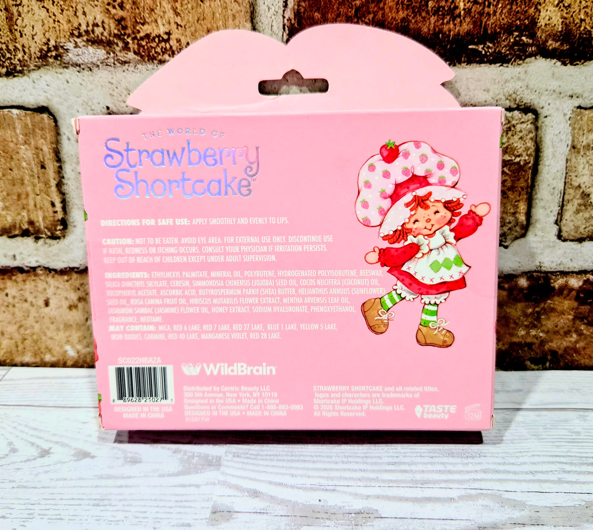 Strawberry Shortcake lip oil gift set box front, 4-piece with character art