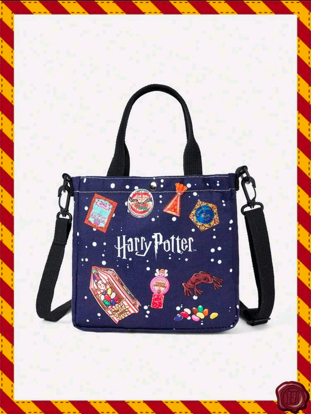 Navy canvas tote bag with black crossbody straps, printed charms, and white polka dots