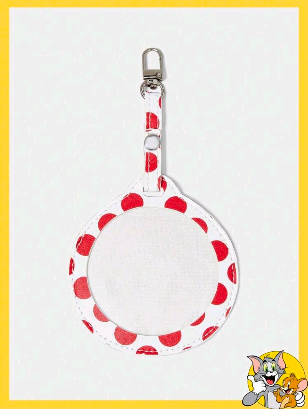 Round fabric bag charm with red polka dots and a silver keychain clasp on top