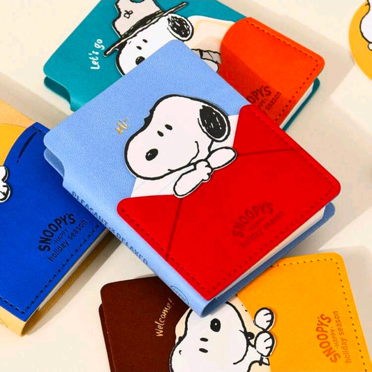Faux leather pocket notebook set covers in blue, orange, and red with Snoopy art
