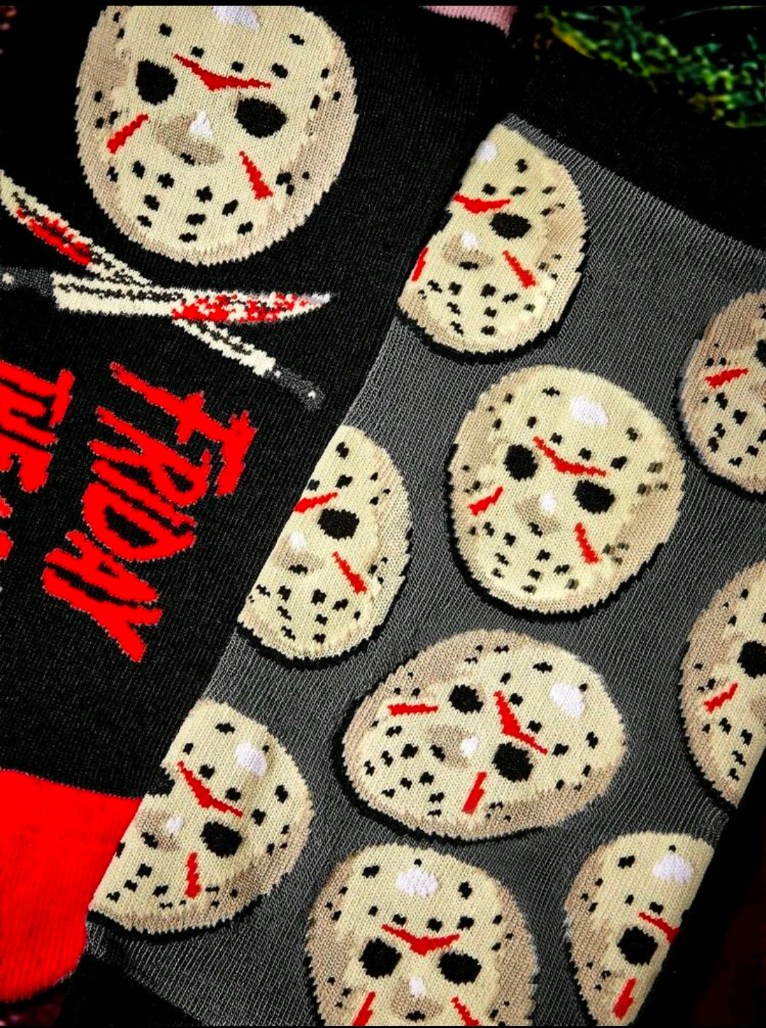 Close-up ankle sock knit with repeating Jason hockey mask faces and red “Friday the 13th”