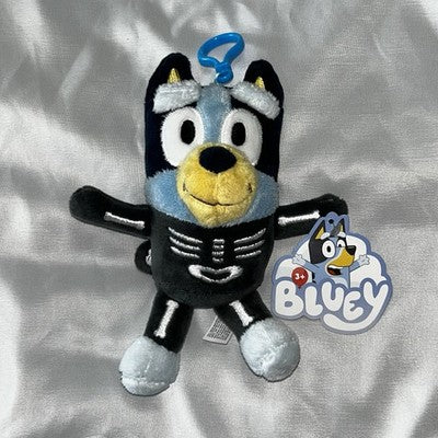 Black skeleton Halloween plush keychain with striped belly and feet, tag attached