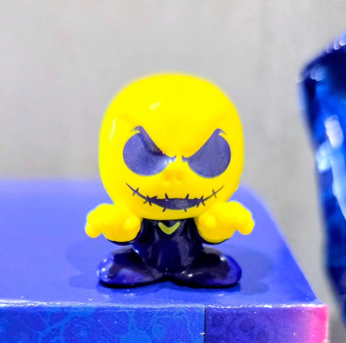 Close-up Jack Skellington Squish'Alots figure with yellow head and dark outfit