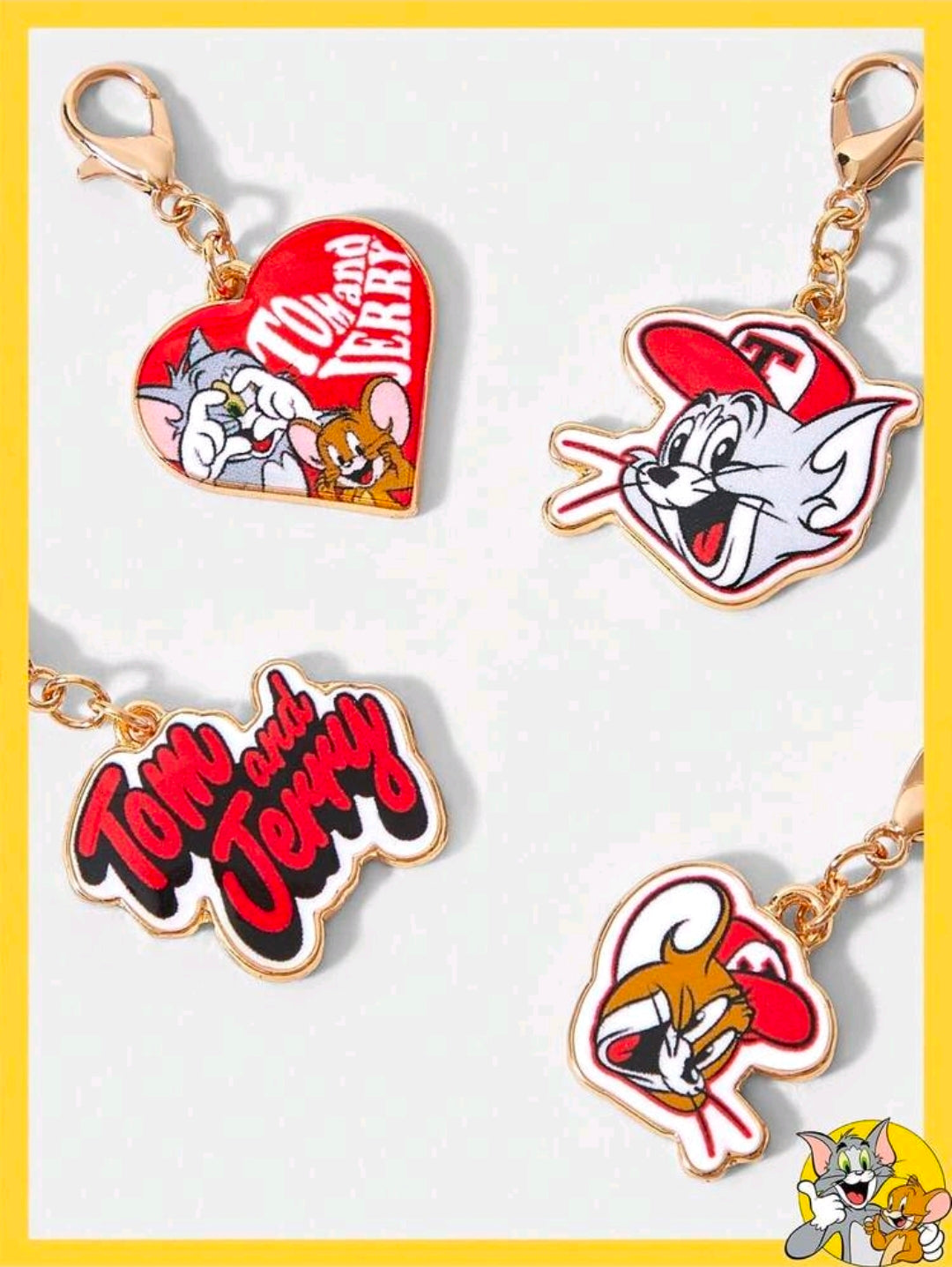 Four gold-tone enamel Tom & Jerry bag charms: heart, cat figure, mouse figure, logo