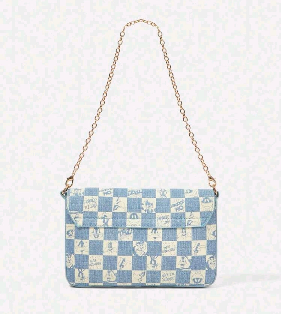 Denim blue patchwork shoulder bag with gold chain strap and front flap.