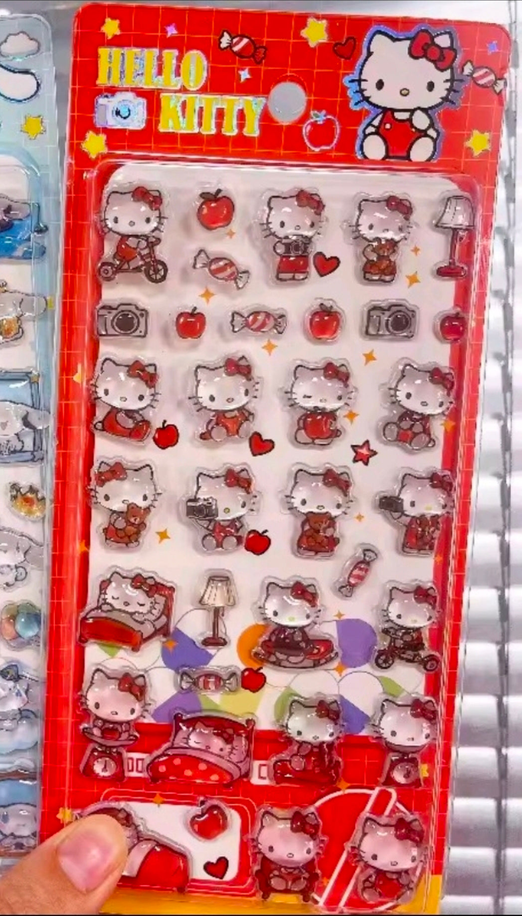 Hello Kitty puffy sticker sheet in red with character faces, hearts, and bows