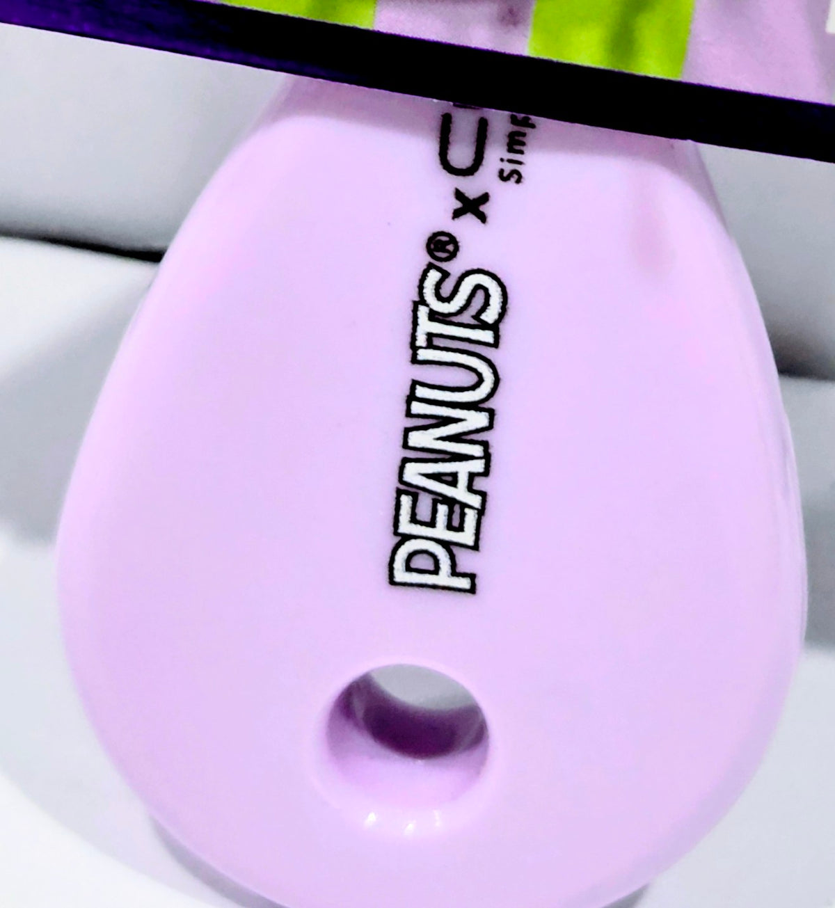 Lilac nail file end with Peanuts x Celavi logo and oval hanging hole
