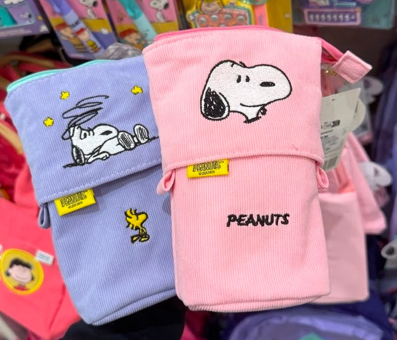 Pink and lavender corduroy pop-up pencil cases with Snoopy embroidery, standing.