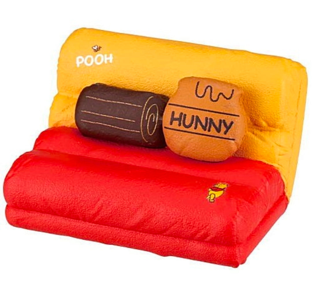 Yellow and red plush bench set with “POOH” and “HUNNY” printed on cushions