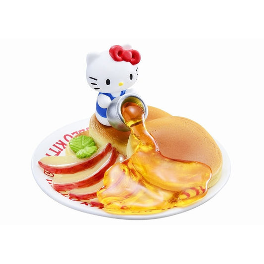 Miniature Hello Kitty pancake figure with syrup and fruit garnish