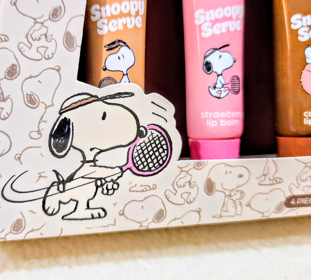 Snoopy Serve lip balm set with strawberry lip balm tube and Snoopy artwork