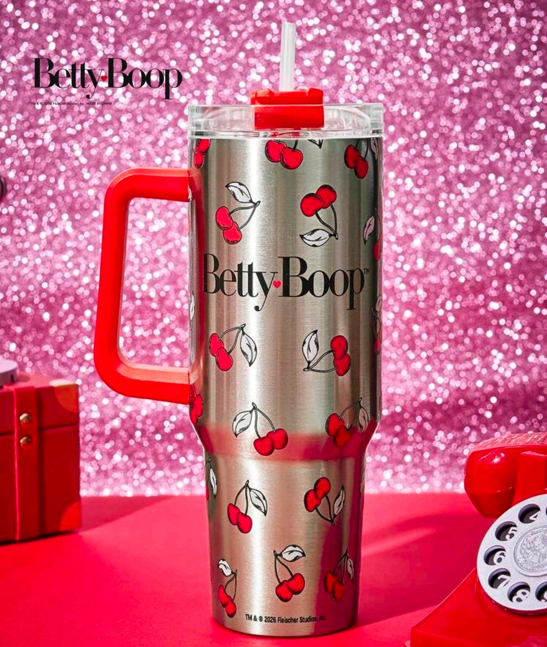 Stainless steel insulated tumbler with Betty Boop text, cherry print, red handle and straw lid.