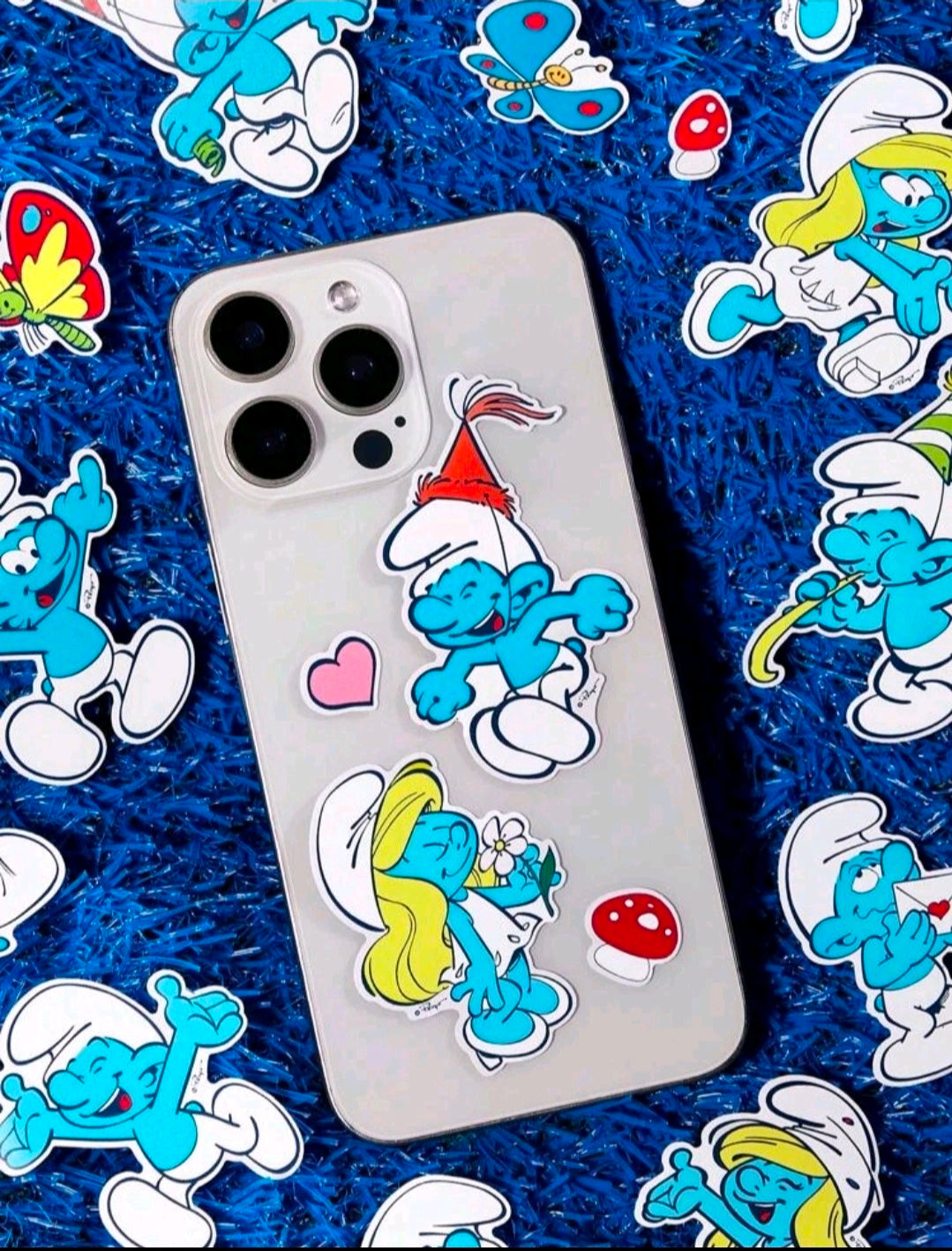 Smurfs vinyl decals on a smartphone case with multiple character stickers