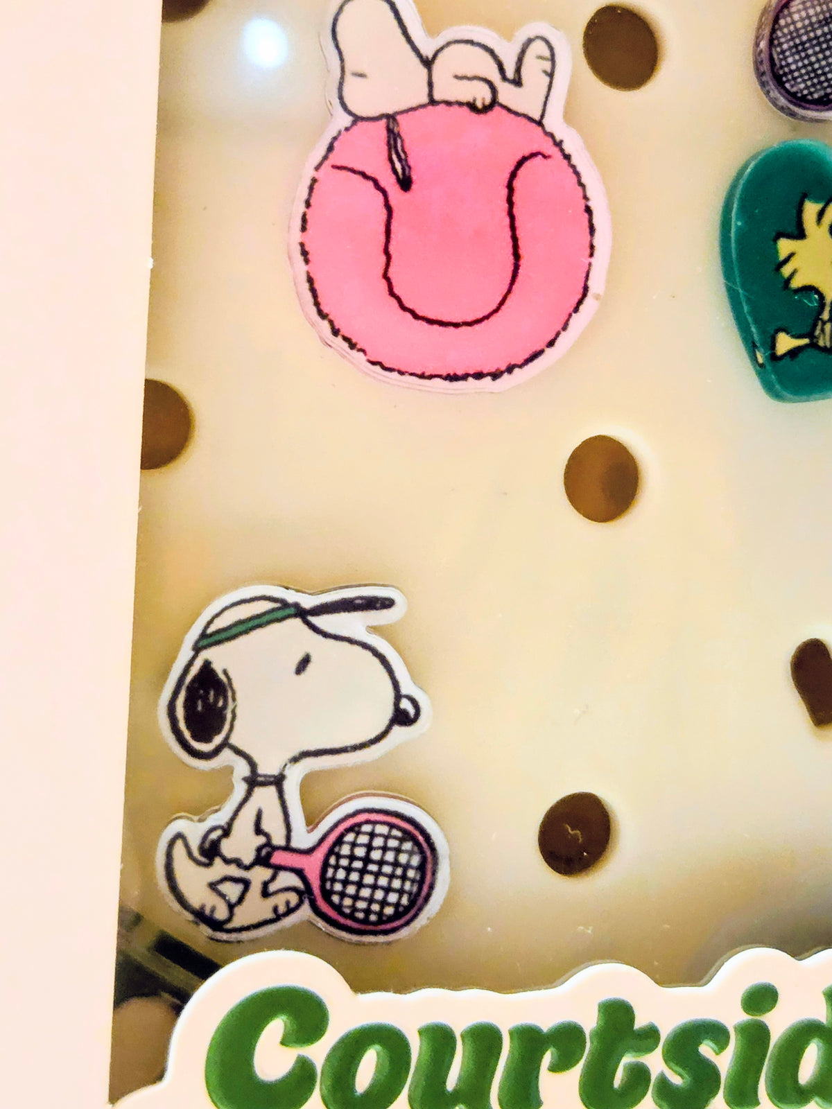 Charm hairbrush card showing Snoopy tennis racket and pink rounded charm pieces