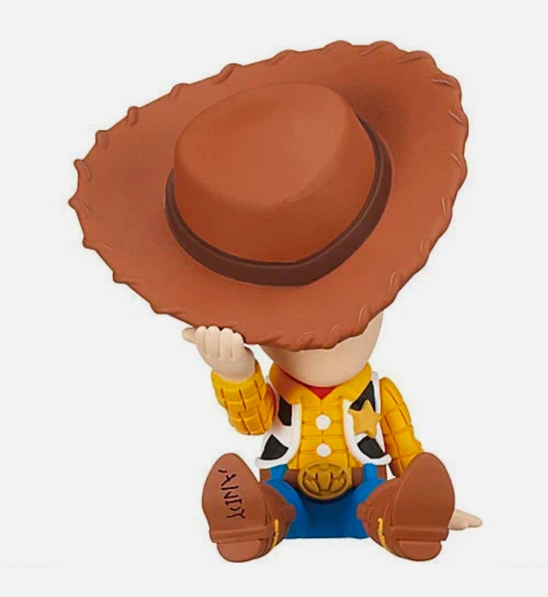 Cowboy gashapon figure with brown hat, blue vest, and yellow jacket details