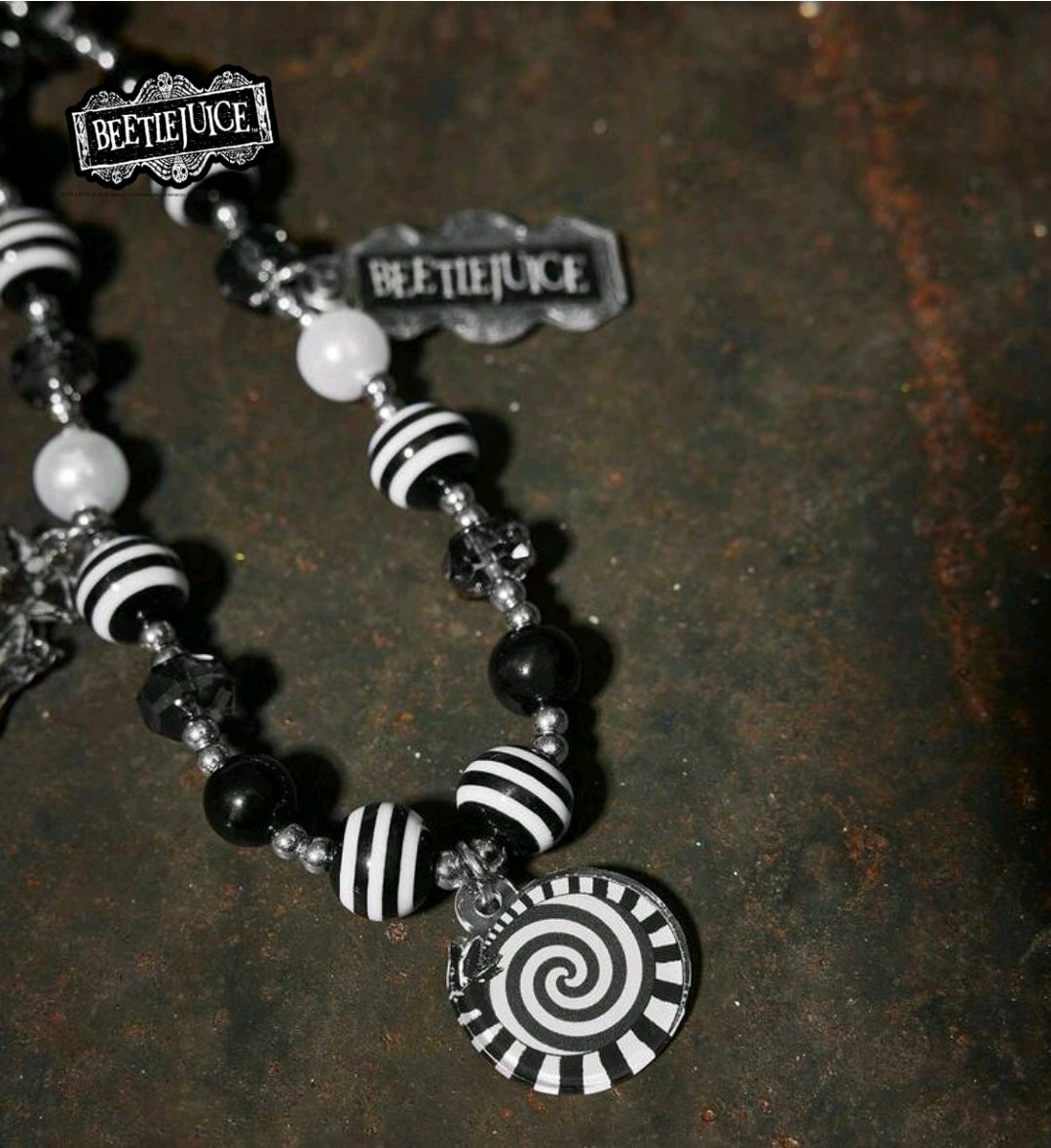 Beetlejuice beaded phone lanyard detail with striped beads and spiral pendant charm
