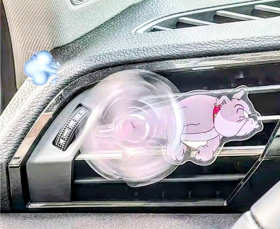 Pink cartoon mouse acrylic air-vent spinner clip on the side of a car vent.