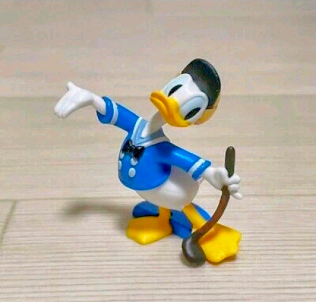 Donald Duck costume figure in blue outfit, yellow shoes, white gloves, holding a brown stick