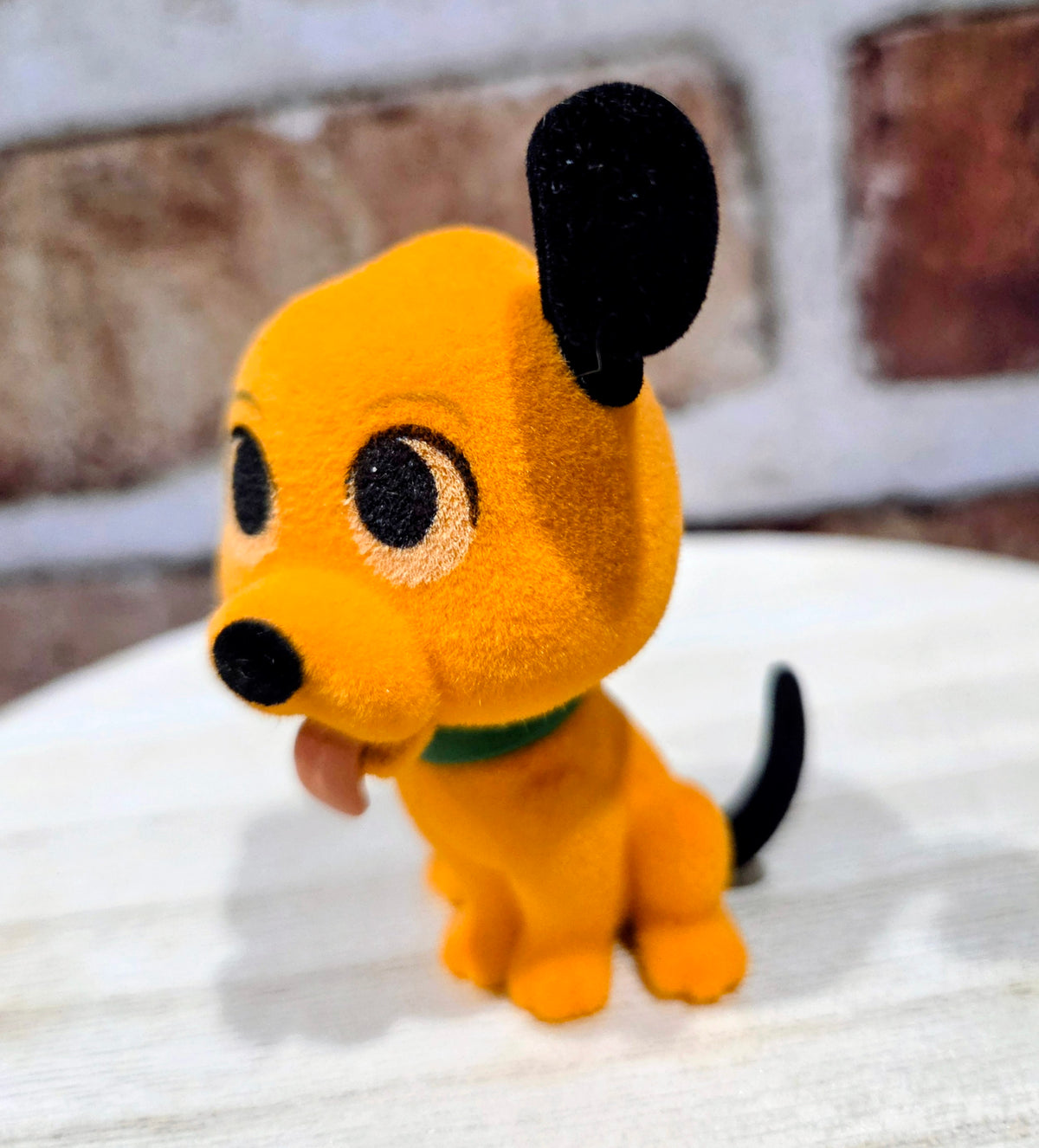 Flocked Pluto mini figure, orange plush with black ears and green collar