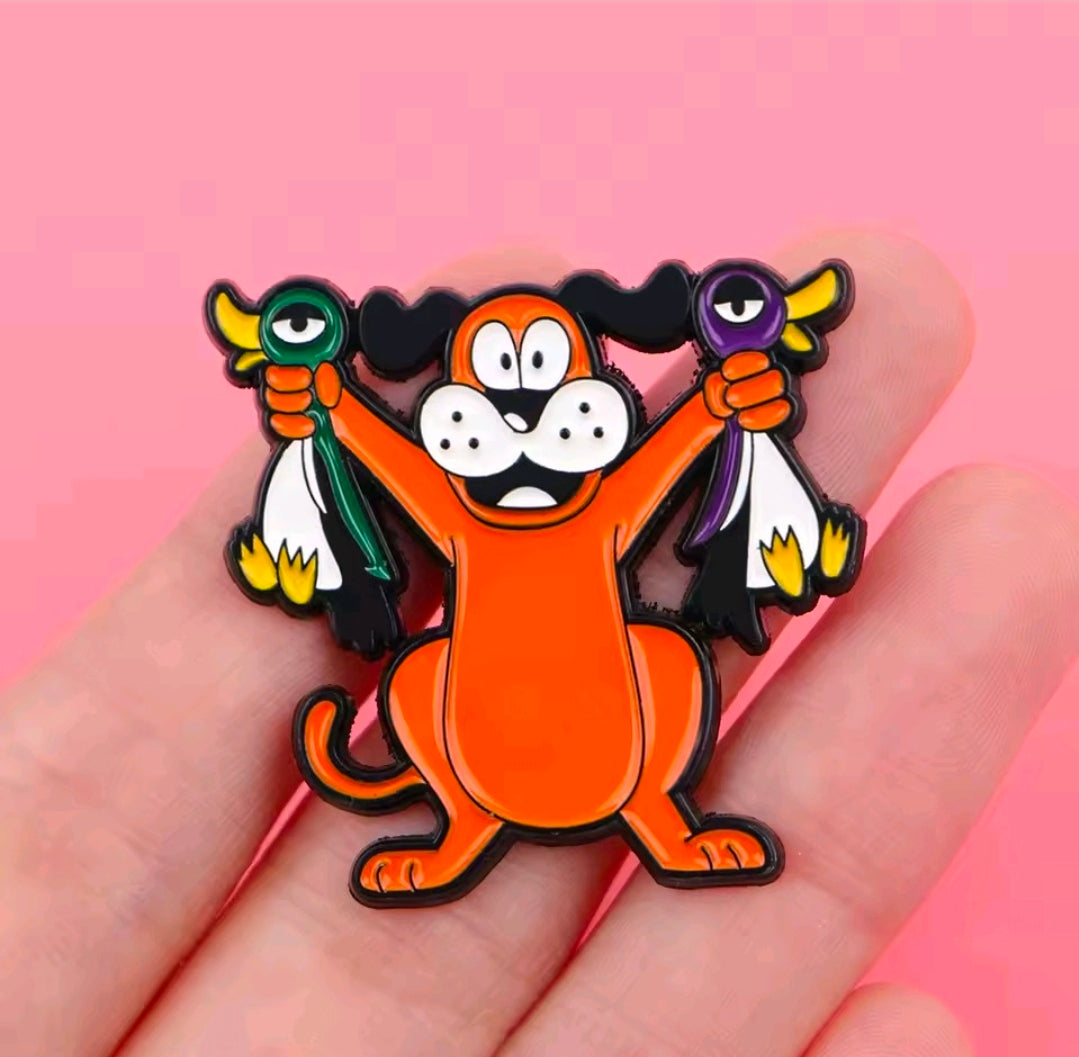 Colorful enamel lapel pin of orange cartoon dog holding green and purple items.
