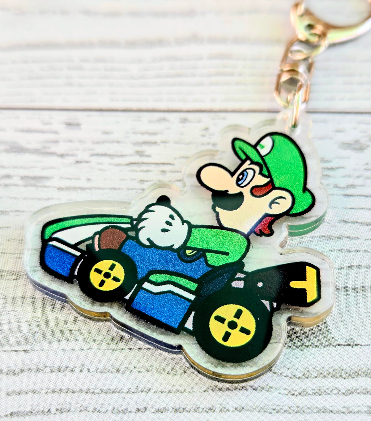Luigi in kart acrylic keychain with gold ring and chain links